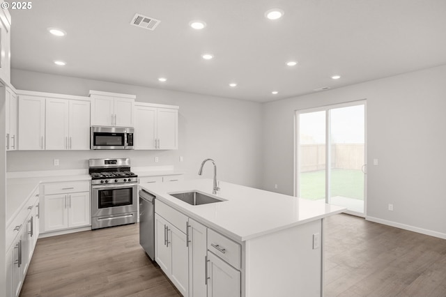 5954 Henshaw St SE, Albany, OR 97322 - kitchen featuring appliances with stainless steel finishes, a sink, recessed lighting, white cabinetry, and light countertops