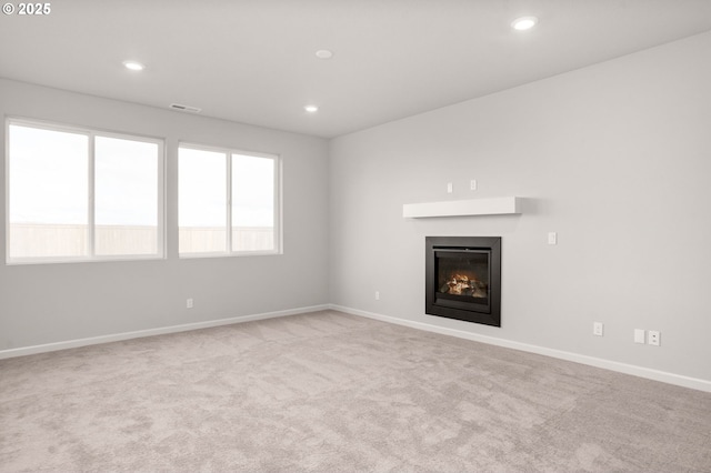 5954 Henshaw St SE, Albany, OR 97322 - unfurnished living room featuring a glass covered fireplace, carpet floors, baseboards, and recessed lighting
