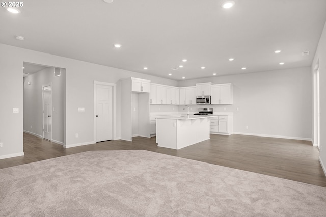 5954 Henshaw St SE, Albany, OR 97322 - kitchen featuring appliances with stainless steel finishes, open floor plan, a sink, a kitchen island with sink, and recessed lighting
