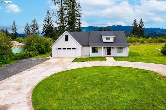 641 E Jones St, Yacolt, WA 98675 - modern farmhouse featuring concrete driveway, a garage, board and batten siding, a front lawn, and a porch