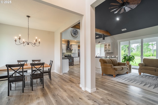 641 E Jones St, Yacolt, WA 98675 - dining space featuring a chandelier, light wood-style flooring, vaulted ceiling, and baseboards