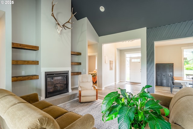 641 E Jones St, Yacolt, WA 98675 - living room with a glass covered fireplace, built in features, light wood-type flooring, baseboards, and high vaulted ceiling