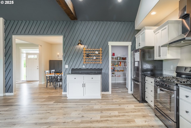 641 E Jones St, Yacolt, WA 98675 - kitchen featuring range with gas cooktop, wall chimney range hood, light wood finished floors, white cabinetry, and beamed ceiling