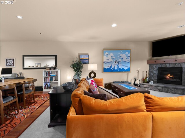 living room with wood finished floors, a fireplace, and recessed lighting