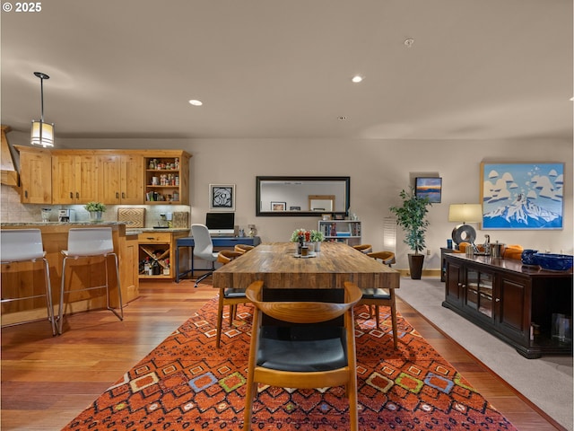 dining space with light wood-type flooring and recessed lighting