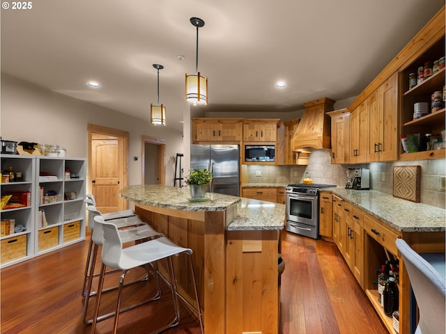 kitchen with appliances with stainless steel finishes, premium range hood, open shelves, decorative backsplash, and dark wood finished floors