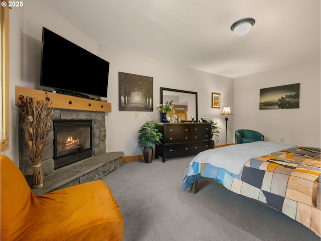carpeted bedroom with a fireplace and baseboards