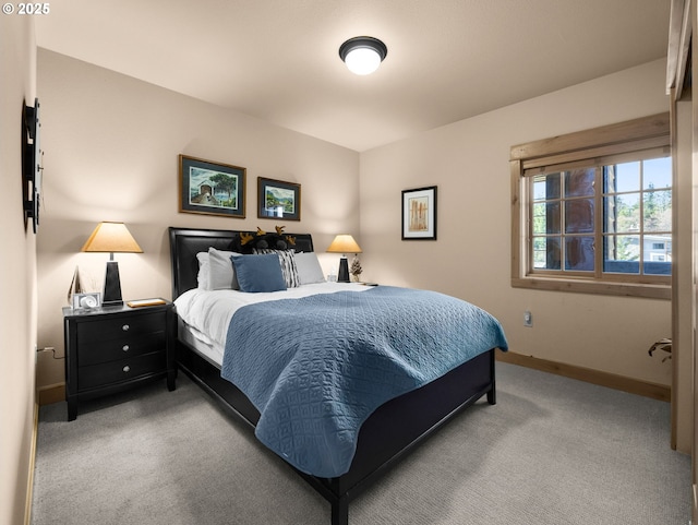 carpeted bedroom featuring baseboards
