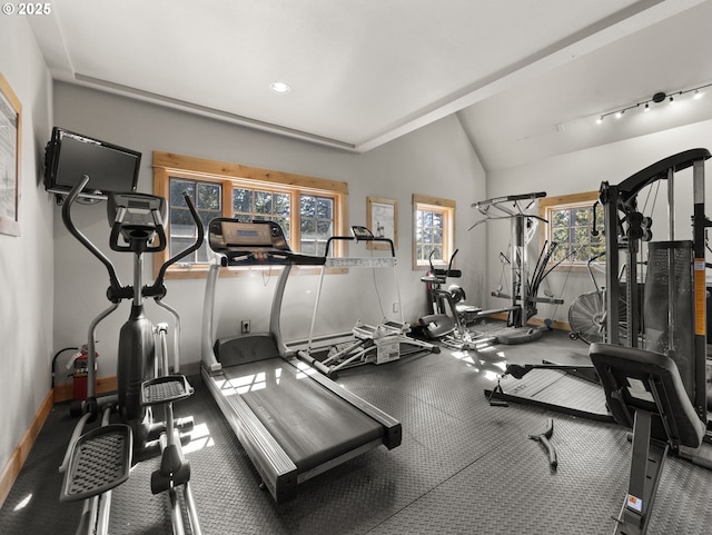 gym featuring baseboards, plenty of natural light, lofted ceiling, and recessed lighting