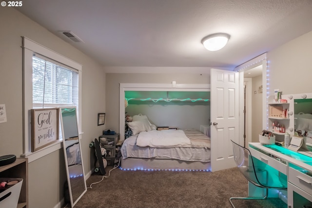 carpeted bedroom featuring visible vents