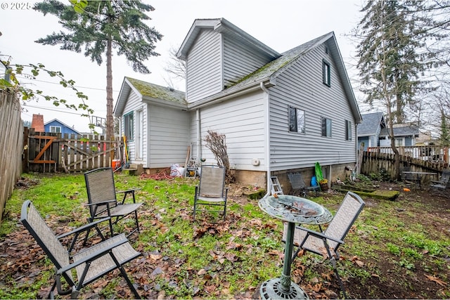 back of property featuring a fenced backyard