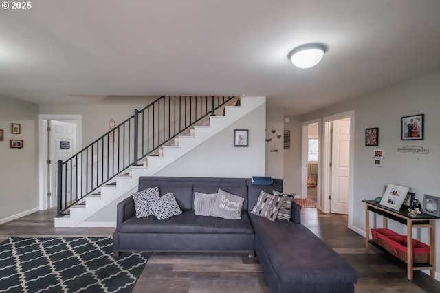 living room with baseboards, wood finished floors, and stairs