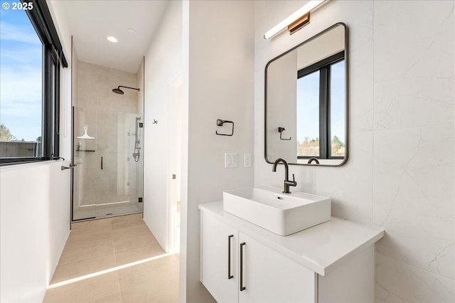 bathroom featuring a stall shower, plenty of natural light, vanity, and tile patterned floors