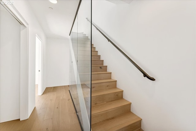 stairway featuring wood finished floors