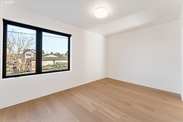 unfurnished room with light wood-style flooring