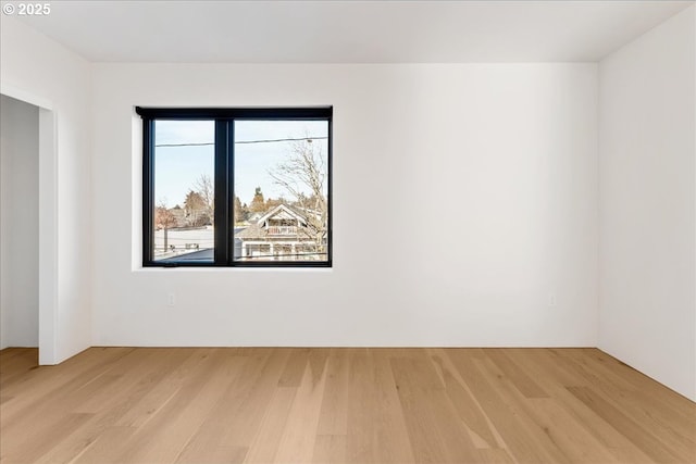 spare room with light wood-type flooring