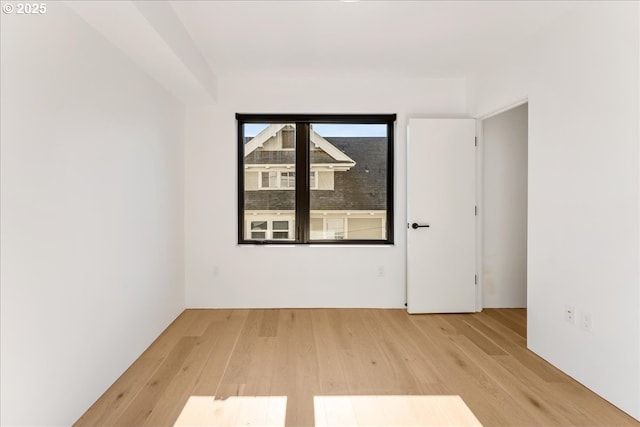 unfurnished room featuring light wood-style flooring