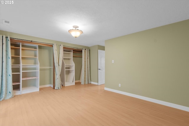 unfurnished bedroom featuring light hardwood / wood-style floors and a textured ceiling