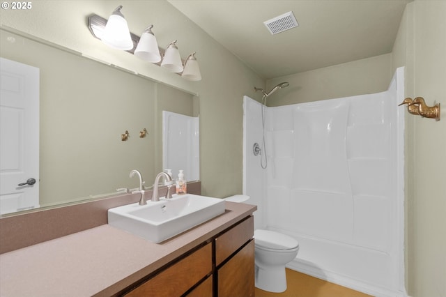 bathroom with vanity, toilet, and walk in shower