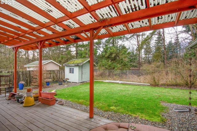 wooden terrace with a yard and a shed