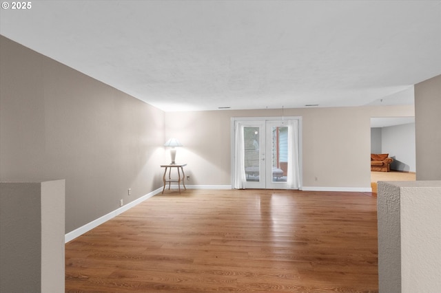 empty room featuring hardwood / wood-style floors and french doors