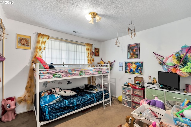 bedroom with carpet floors, visible vents, and a textured ceiling