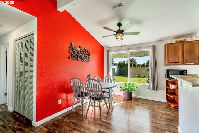 dining room with ceiling fan, dark wood-style flooring, visible vents, and baseboards