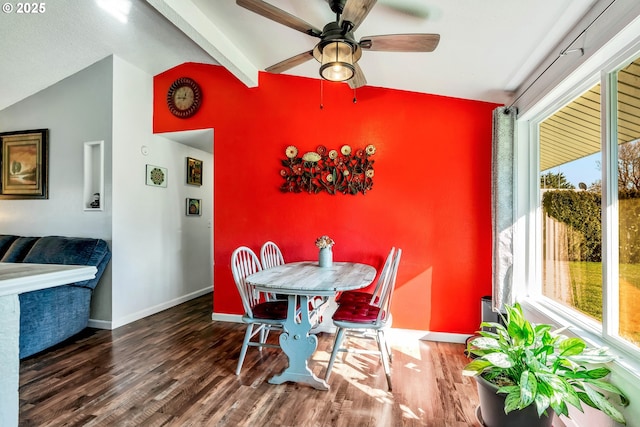 dining space with lofted ceiling with beams, plenty of natural light, wood finished floors, and baseboards