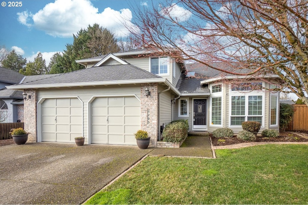 8295 SW 158th Pl, Beaverton, OR 97007 - front facade featuring a garage and a front yard