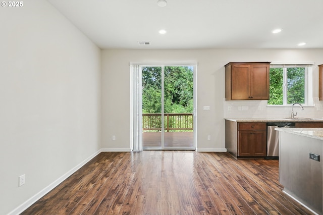 10090 NW Bartlett Loop, North Plains, OR 97133 - kitchen featuring stainless steel dishwasher, dark wood finished floors, healthy amount of natural light, light stone counters, and recessed lighting