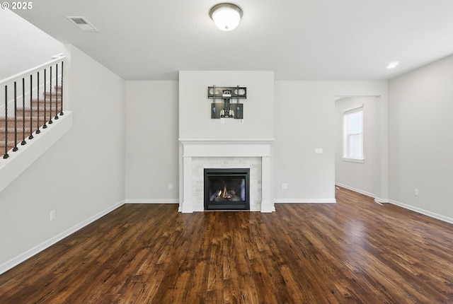 10090 NW Bartlett Loop, North Plains, OR 97133 - unfurnished living room with dark wood-style flooring, a fireplace, and stairs