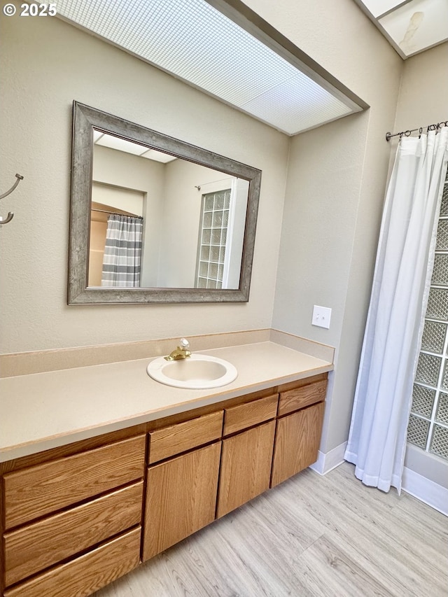 bathroom with hardwood / wood-style flooring and vanity