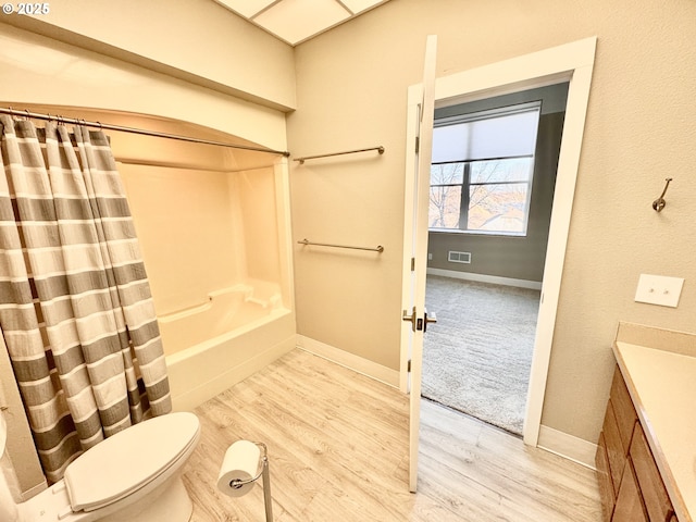 full bathroom featuring toilet, vanity, shower / bathtub combination with curtain, and hardwood / wood-style floors