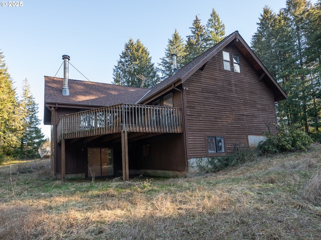 back of house with a deck