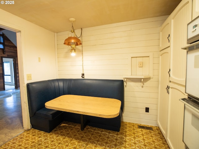 sitting room featuring wooden walls