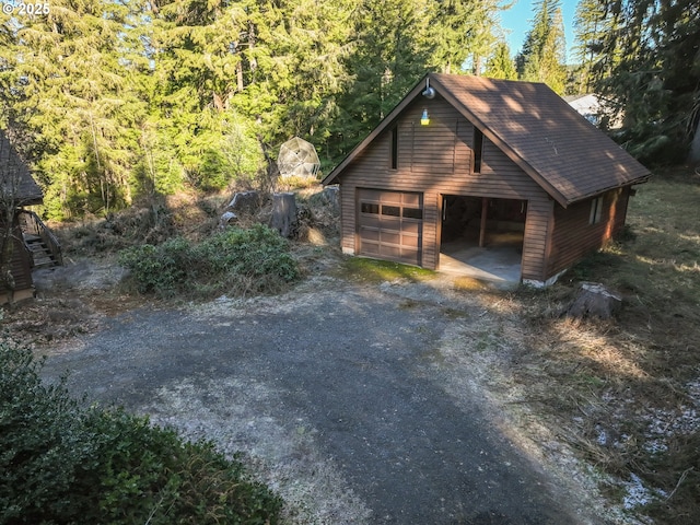 view of property exterior featuring a garage and an outdoor structure