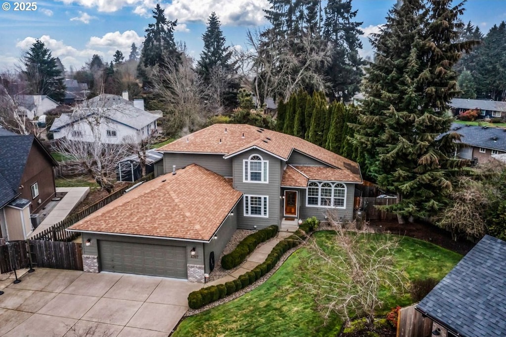 front of property with a front yard and a garage