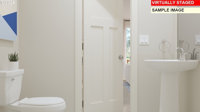 bathroom with baseboards and toilet
