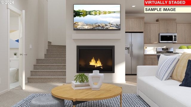 living area with stairs, baseboards, a warm lit fireplace, light colored carpet, and recessed lighting
