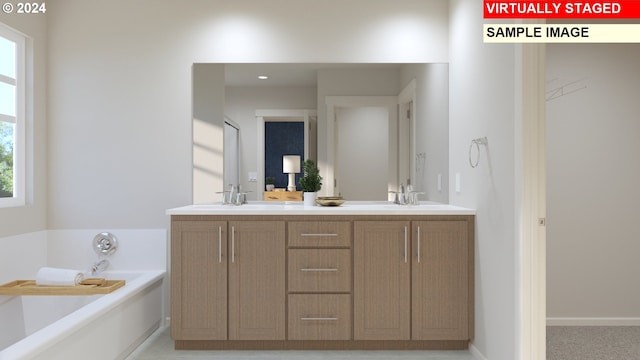 bathroom featuring double vanity, a sink, and a bath