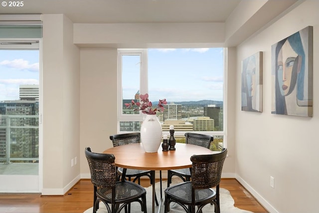 1500 SW 11th Ave Unit 2404, Portland, OR 97201 - dining area featuring wood finished floors, healthy amount of natural light, and baseboards