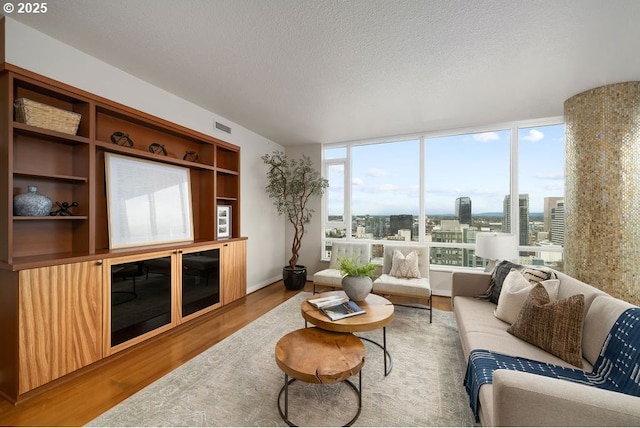 1500 SW 11th Ave Unit 2404, Portland, OR 97201 - living room with wood finished floors and a textured ceiling