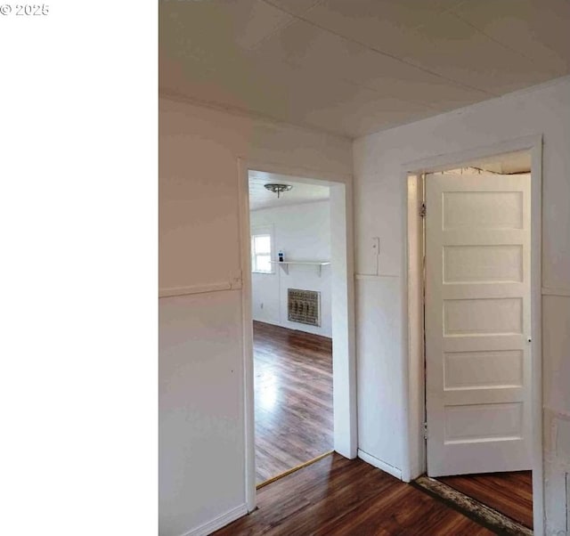 corridor with hardwood / wood-style floors