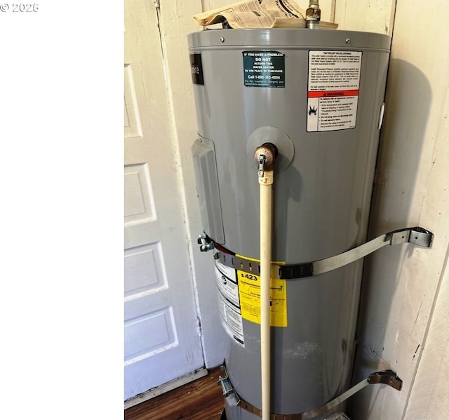 utility room with strapped water heater