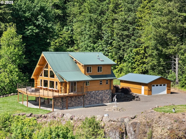133 Outlook Ln, Mossyrock, WA 98564 - back of property featuring a detached garage, a forest view, a wooden deck, and a metal roof