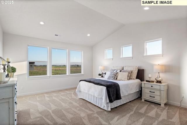 bedroom with light carpet and vaulted ceiling