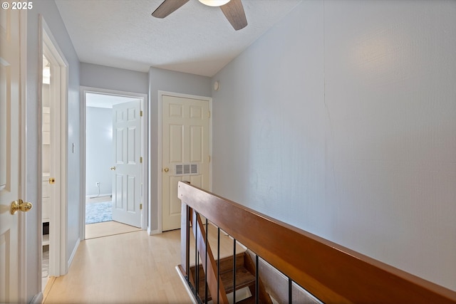 1735 NW Lakeway Ln, Beaverton, OR 97006 - corridor with light wood-style floors and a textured ceiling