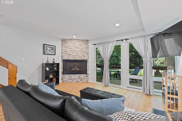1735 NW Lakeway Ln, Beaverton, OR 97006 - living area with wood finished floors, a stone fireplace, and recessed lighting