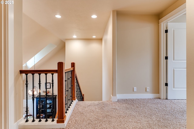corridor with recessed lighting, baseboards, carpet floors, and an upstairs landing