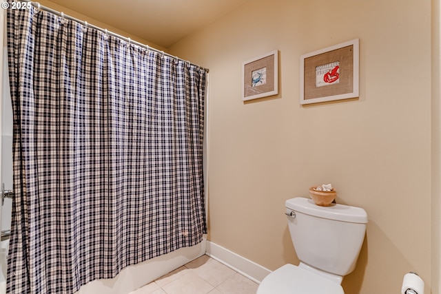 bathroom with tile patterned floors, baseboards, toilet, and shower / bath combination with curtain